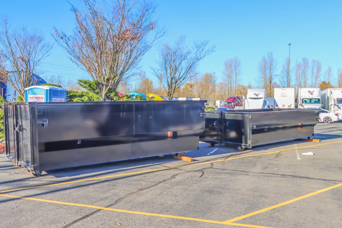 Professional dumpster rental service with roll-off container on residential driveway in Roselle Park